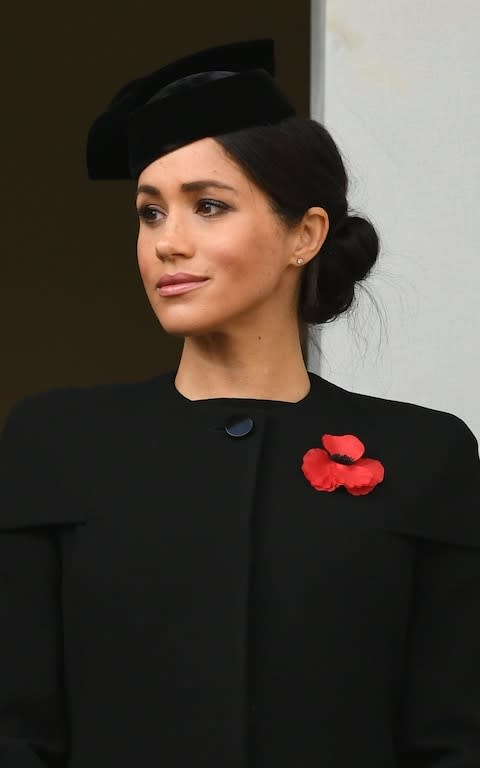 The Duchess of Sussex watching the service at the Cenotaph from the balcony of the Foreign and Commonwealth Office - Credit:  James Whatling Photography