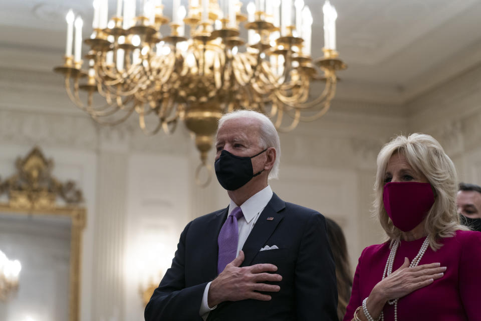 President Joe Biden, accompanied by first lady Jill Biden, places his hand over his heart during a performance of the national anthem, during a virtual Presidential Inaugural Prayer Service in the State Dinning Room of the White House, Thursday, Jan. 21, 2021, in Washington. (AP Photo/Alex Brandon)