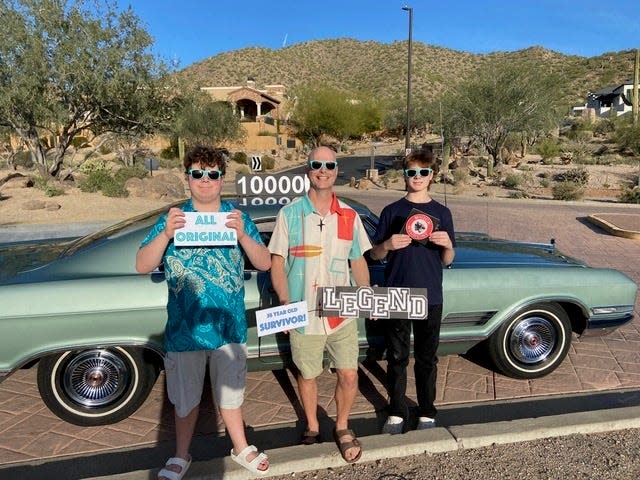 Anson Renshaw and his sons Milton, 16, and Lloyd, 14, celebrate their 1966 Buick Wildcat topping 10,000 miles in Mesa, Arizona. The Buick still has its original Goodyear tires.