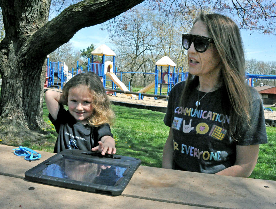 Wesley Hildebrand carries an iPad he uses to in order to communicate with people. His mom, Stacey Everhart, is working to get large communication boards installed at parks, pools, schools and other locations for children and adults with similar issues as Wesley's.
(Credit: MIKE SCHENK/THE DAILY RECORD`)