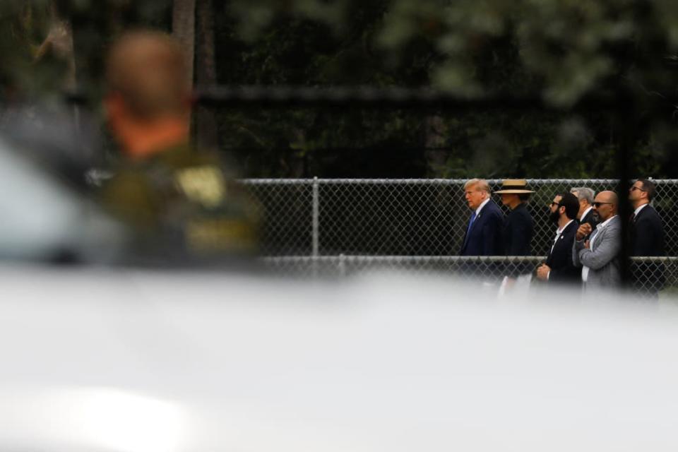 Donald Trump walks into his son’s commencement ceremony with Secret Service agents behind him.