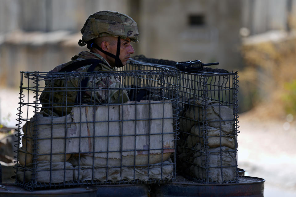 A Lebanese army soldier stands guards at the entrance of Palestinian refugee camp of Ein el-Hilweh during clashes between members of the Palestinian Fatah group and Islamist militants near the southern port city of Sidon, Lebanon, Sunday, Sept. 10, 2023. Islamist factions in Lebanon's largest Palestinian refugee camp said Sunday they will abide by a cease-fire after three days of clashes killed at least five people and left hundreds of families displaced. (AP Photo/Bilal Hussein)