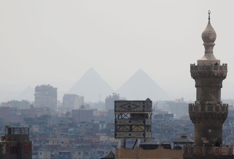 A view of Old Cairo with a mosque minaret and the Great Pyramids following the government instructions as Egypt ramps up its efforts to slow the spread of the coronavirus disease (COVID-19) in Cairo