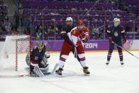 USA defenseman Ryan Suter and Russia forward Alexander Ovechkin jockey for position as USA goaltender Jonathan Quick defends the goal in the first period of a men's ice hockey game at the 2014 Winter Olympics, Saturday, Feb. 15, 2014, in Sochi, Russia. (AP Photo/Mark Humphrey)