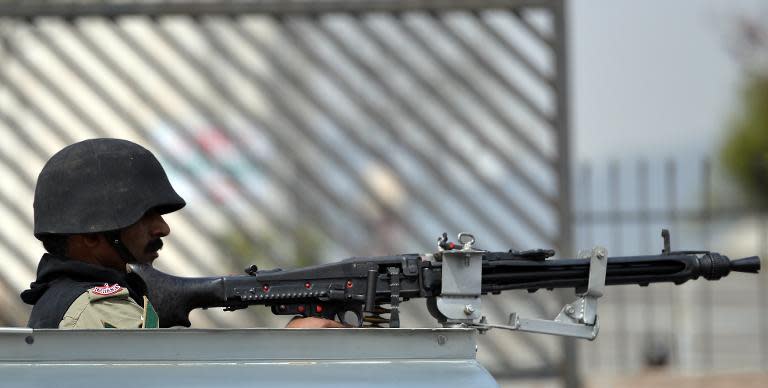 A Pakistani paramilitary soldier keep watch with a machine gun outside a court in Islamabad on March 14, 2014