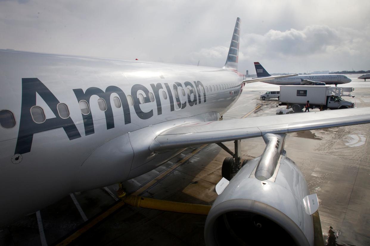 FILE - In this Feb. 26, 2014 file photo, an American Airlines Airbus A319 is parked at a gate at Philadelphia International Airport.