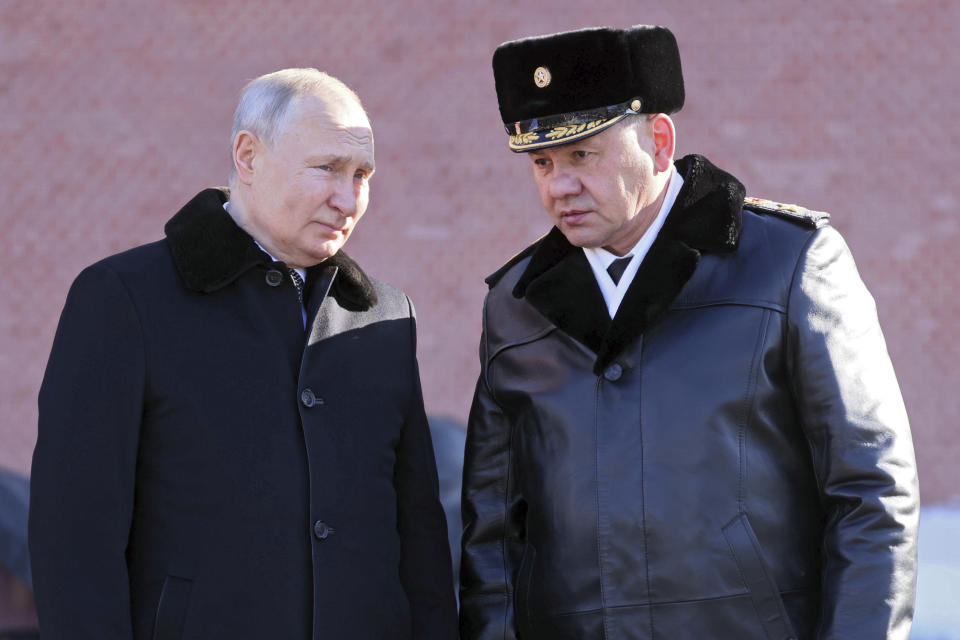 Russian President Vladimir Putin, left, and Russian Defence Minister Sergei Shoigu attend a wreath-laying ceremony at the Unknown Soldier's Grave in the Alexander Garden during the national celebrations of the "Defender of the Fatherland Day" in Moscow, Russia, Thursday, Feb. 23, 2023. (Mikhail Metzel, Sputnik, Kremlin Pool Photo via AP)