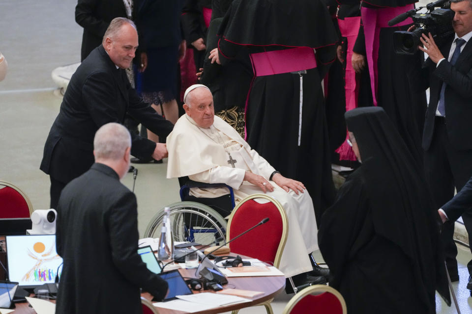 Pope Francis arrives for the opening session of the 16th General Assembly of the Synod of Bishops in the Paul VI Hall at The Vatican, Wednesday, Oct. 4, 2023. Pope Francis is convening a global gathering of bishops and laypeople to discuss the future of the Catholic Church, including some hot-button issues that have previously been considered off the table for discussion. Key agenda items include women's role in the church, welcoming LGBTQ+ Catholics, and how bishops exercise authority. For the first time, women and laypeople can vote on specific proposals alongside bishops. (AP Photo/Gregorio Borgia)