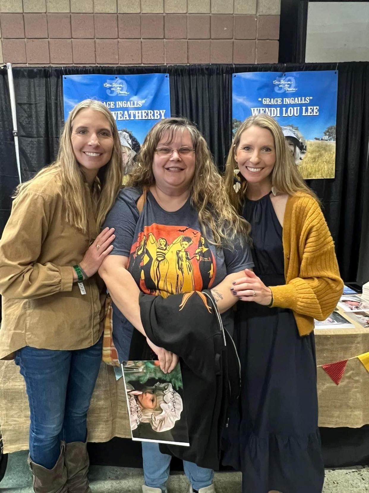 Twins pose with fan, Tiffany Verran. Brenda Turnbaugh (left) and Wendi Lou Lee, right.