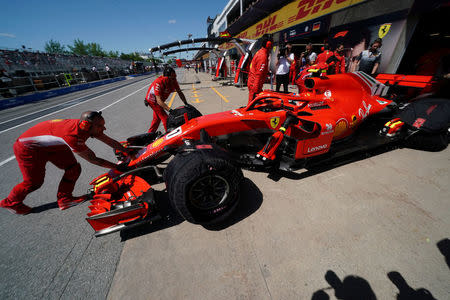 Kimi Raikkonen is pushed back into the garage at Circuit Gilles Villeneuve during a practice session for the F1 race in Montreal, Quebec, Canada, June 8, 2018. REUTERS/Carlo Allegri