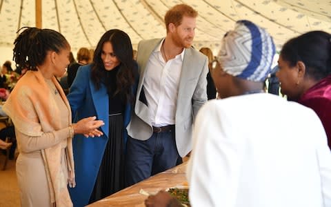 The Duke and Duchess of Sussex with Doria Ragland in the Kensington Palace tent - Credit: BEN STANSALL /AFP
