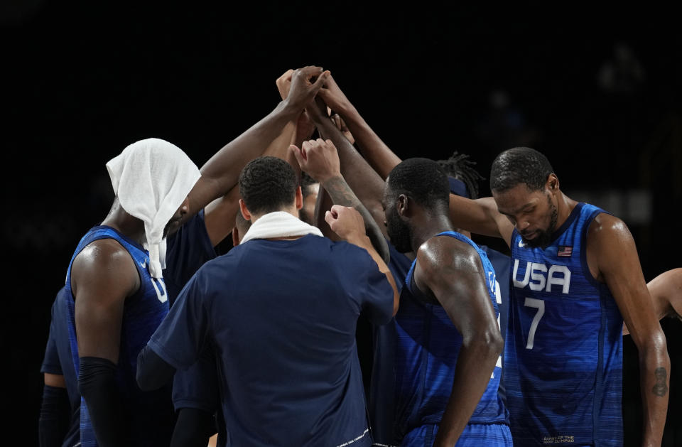 United States' Kevin Durant (7), right, and teammates celebrate their win in the men's basketball quarterfinal game against Spain at the 2020 Summer Olympics, Tuesday, Aug. 3, 2021, in Saitama, Japan. (AP Photo/Eric Gay)