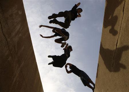 Members of Egy PK, one of the first Parkour groups in Egypt, execute stunts during a street performance in Cairo in this February 10, 2010 file photo. REUTERS/Tarek Mostafa/Files