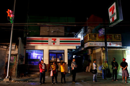 Alejandro Galasao, 58, street sweeper, waits for a bus going to work, in San Jose Del Monte City, Bulacan province, Philippines, November 15, 2018. Galasao leaves his home at 3:30 a.m. every day to avoid the traffic during rush hour. "If I go to work at rush hour, it takes me three hours to arrive. But without traffic, my travel time is just an hour." REUTERS/Eloisa Lopez