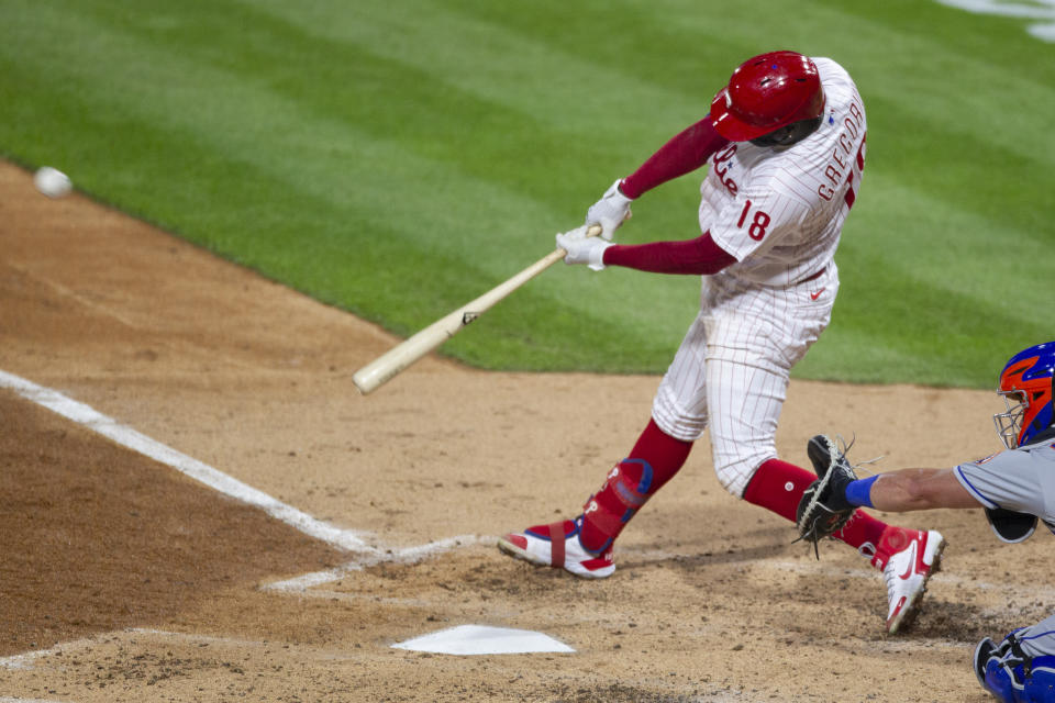 Philadelphia Phillies Didi Gregorius (18) hits a home run during the fourth inning of a baseball game against the New York Mets, Tuesday, April 6, 2021, in Philadelphia. (AP Photo/Laurence Kesterson)