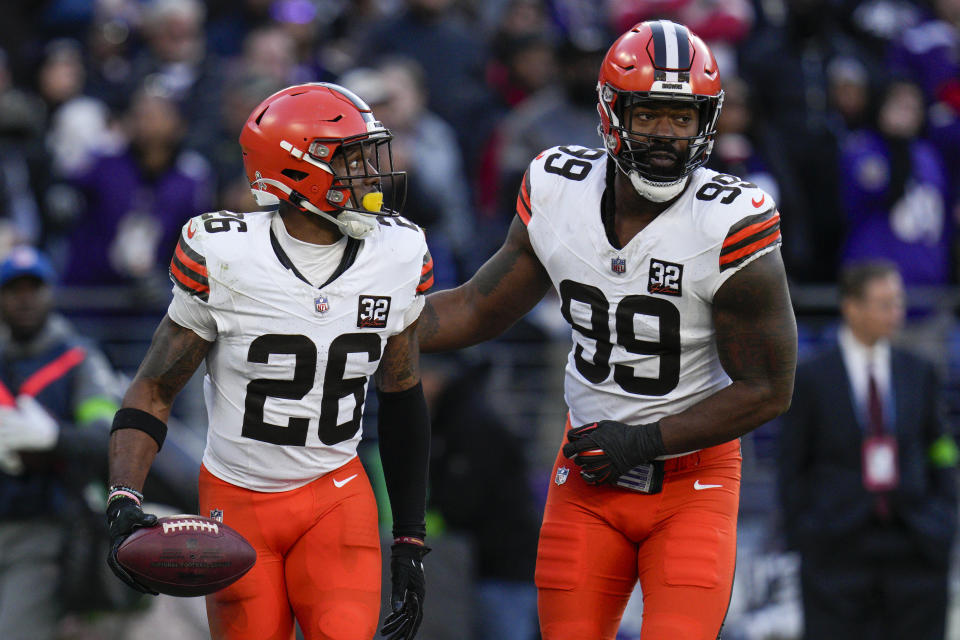 Nov 12, 2023; Baltimore, Maryland, USA; Cleveland Browns safety Rodney McLeod (26) celebrates a defensive play against the Baltimore Ravens with defensive end Za’Darius Smith (99) during the second half at M&T Bank Stadium. Mandatory Credit: Jessica Rapfogel-USA TODAY Sports