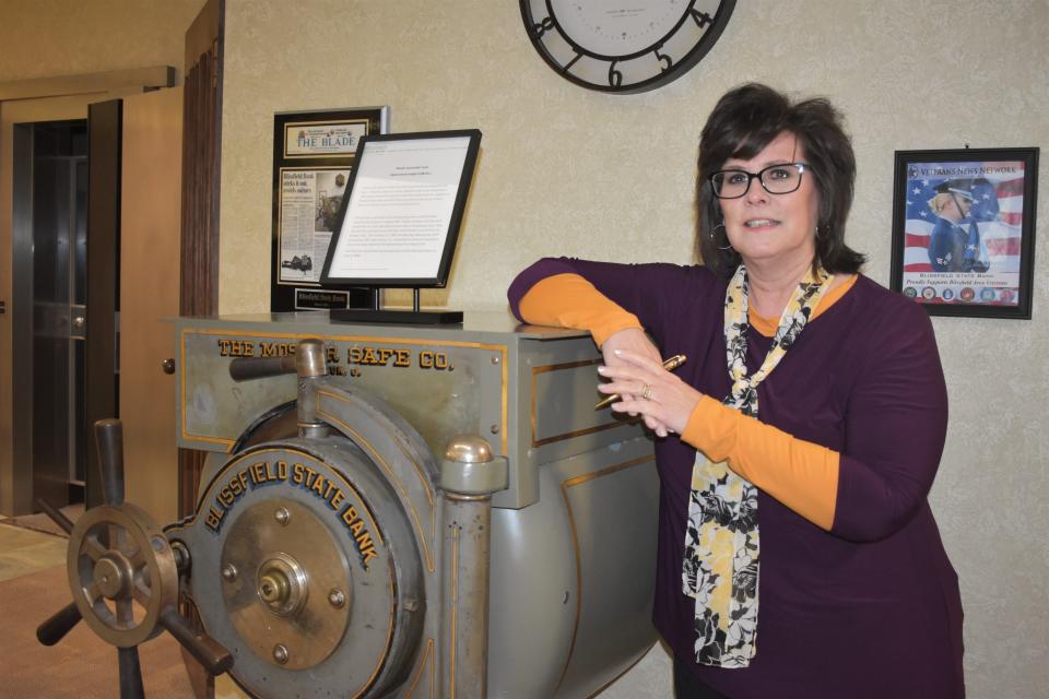 Julie Goll, Blissfield State Bank's 13th president and CEO, stands alongside the historic Mosler cannonball vault, which is housed inside the state bank's main office in Blissfield, 204 E. Jefferson St. The vault is estimated to weight about 4,000 pounds. There is no record of when the vault was purchased by the bank. There is, however, strong indication it was purchased in 1893 when the bank changed its name from Gilmore & Co. Bankers to Blissfield State Bank and the office was built on the corner of South Lane and East Adrian streets in the downtown district.