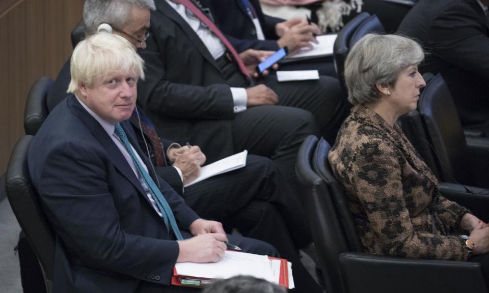 Boris Johnson, left, sits behind Theresa May