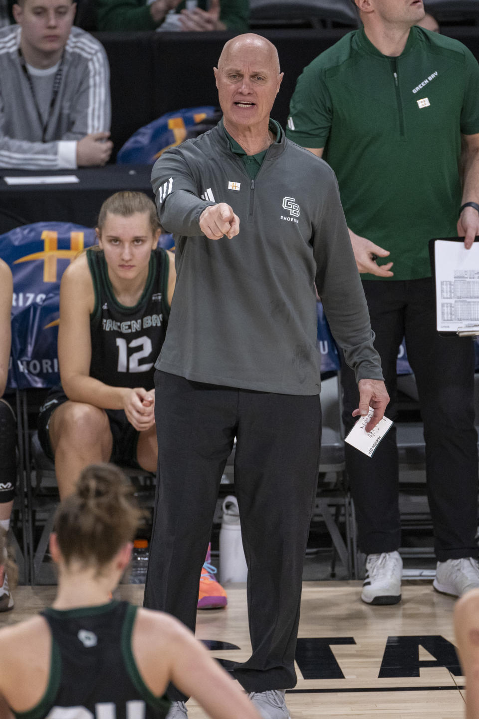 Green Bay head coach Kevin Borseth gestures during the second half against Cleveland State in the championship game of the women's NCAA college basketball Horizon League Conference Tuesday, March 12, 2024, in Indianapolis. (AP Photo/Doug McSchooler)