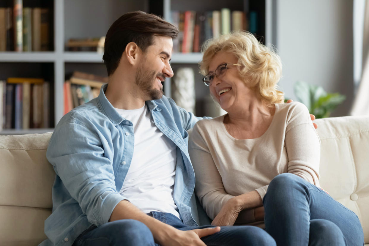 Overjoyed mature mother and adult son talking to each other