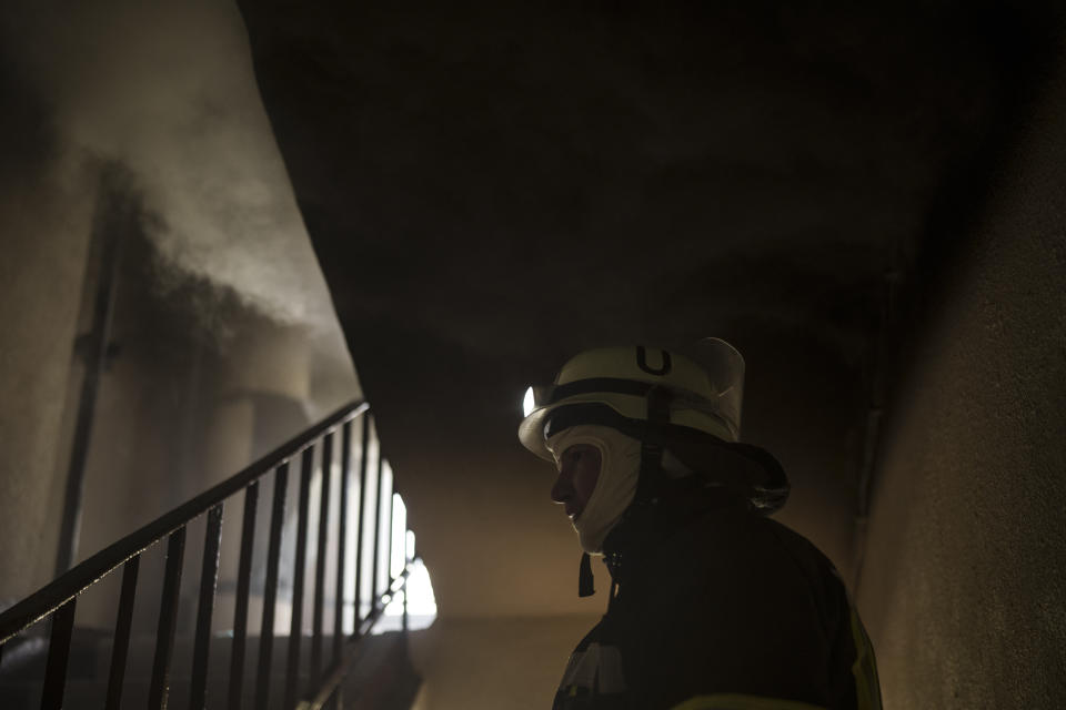 A firefighter works to extinguish a fire in an apartment following a Russian bombardment in Kharkiv, Ukraine, Monday, April 25, 2022. (AP Photo/Felipe Dana)
