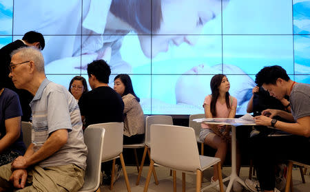 People visit a sales centre of LP6 property development by Nan Fung Group in Hong Kong, China August 26, 2018. Picture taken August 26, 2018. REUTERS/Bobby Yip