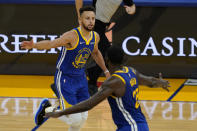 Golden State Warriors guard Stephen Curry, top, celebrates with forward Draymond Green during the second half of an NBA basketball game against the Cleveland Cavaliers in San Francisco, Monday, Feb. 15, 2021. (AP Photo/Jeff Chiu)