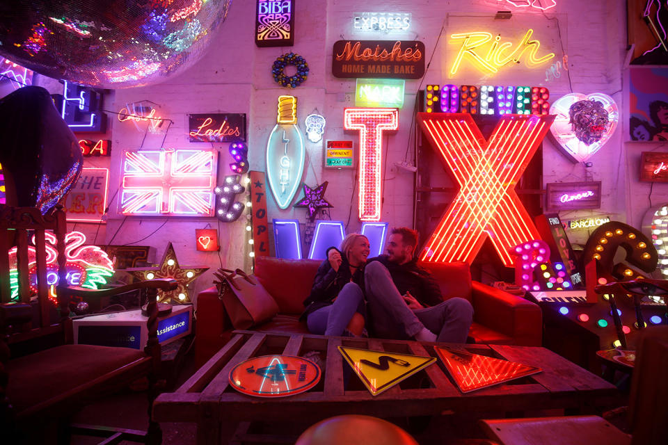 <p>A couple laugh as they cuddle on a sofa looking at the neon signs and artworks in God’s Own Junkyard gallery and cafe in London, Britain, March 31, 2017. (Photo: Russell Boyce/Reuters) </p>