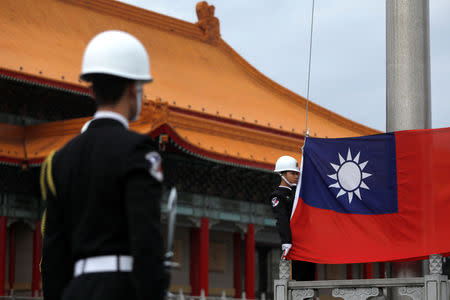 Military honour guards attend a flag-raising ceremony at Chiang Kai-shek Memorial Hall, in Taipei, Taiwan March 16, 2018. REUTERS/Tyrone Siu