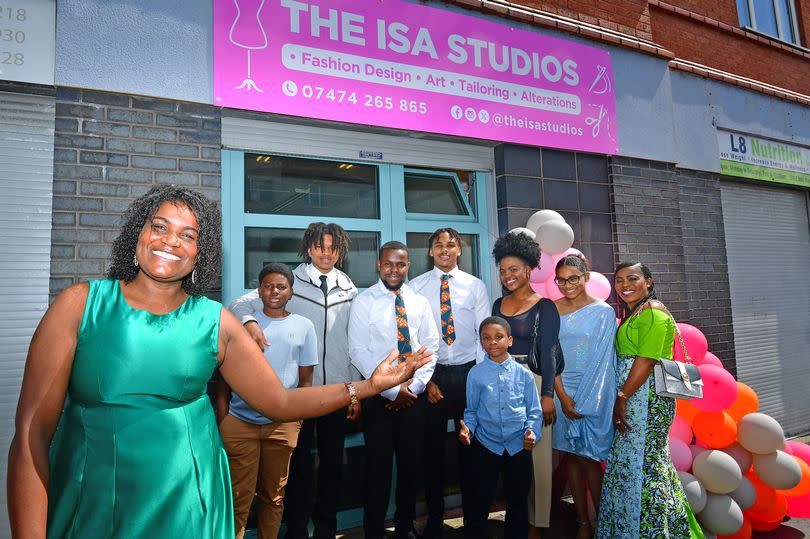 Isabel Lopes and her family at her new clothes design shop on Upper Warwick Street in Toxteth. Photo by Colin Lane