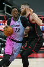 Miami Heat center Bam Adebayo (13) crashes into Toronto Raptors center Aron Baynes (46) during the first half of an NBA basketball game Wednesday, Jan. 20, 2021, in Tampa, Fla. (AP Photo/Chris O'Meara)