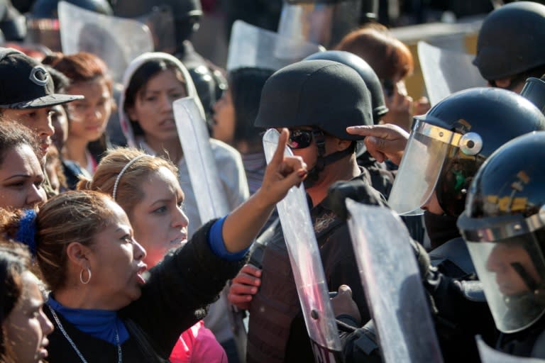 Relatives of inmates argue with the riot police outside the Topo Chico prison in the northern city of Monterrey in Mexico where 49 people died in a prison riot on February 11, 2016