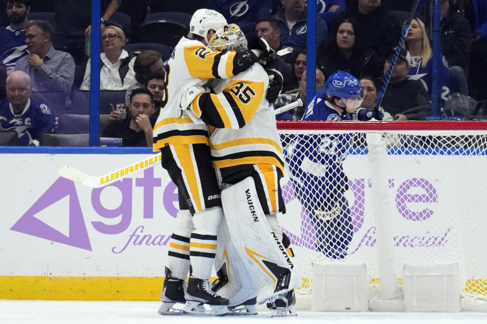 Pittsburgh Penguins goaltender Tristan Jarry (35) celebrates with defenseman Marcus Pettersson (28) after the team defeated the Tampa Bay Lightning during an NHL hockey game Thursday, Nov. 30, 2023, in Tampa, Fla. (AP Photo/Chris O'Meara)