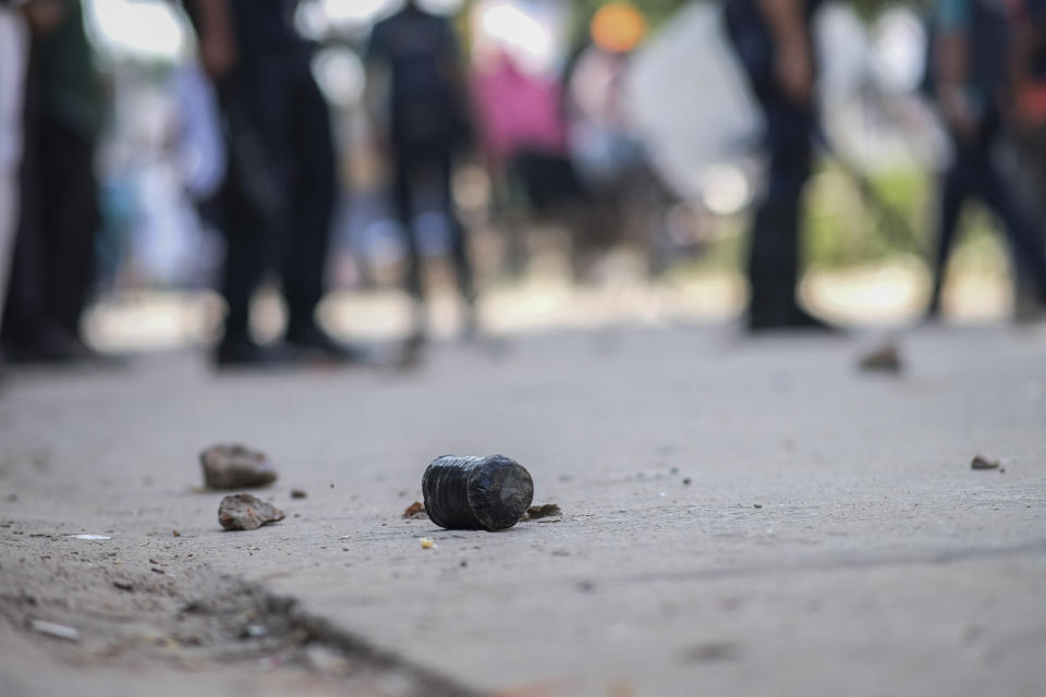 An unexploded bomb lies on the ground as police clash with activists of main opposition Bangladesh Nationalist Party (BNP) who were trying to enforce a three-day blockade in Dhaka, Bangladesh, Tuesday, Oct.31, 2023. BNP has called for country-wide blockade to demand the resignation of Prime Minister Sheikh Hasina and the transfer of power to a non-partisan caretaker government to oversee general elections. (AP Photo/Mahmud Hossain Opu)