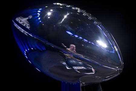 Head coach Pete Carroll of the Seattle Seahawks is reflected in the Vince Lombardi trophy as he speaks during a news conference ahead of the Super Bowl in New York, January 31, 2014. REUTERS/Carlo Allegri