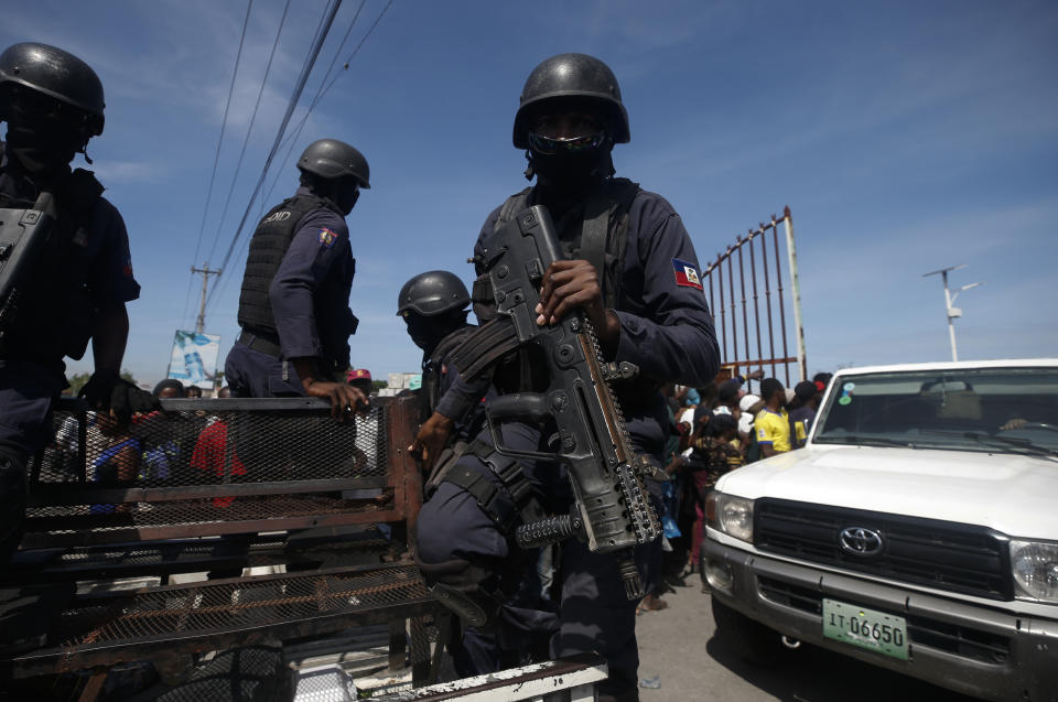 Police drive away after providing security for the federal government distribution of food and school supplies at the mayor's office in Cite Soleil, Port-au-Prince, Haiti, Thursday, Oct. 3, 2019. President Jovenel Moise's administration tried to alleviate the economic crunch on Thursday by distributing plates of rice and beans, sacks of rice, and school backpacks filled with four notebooks and two pens. (AP Photo/Rebecca Blackwell)