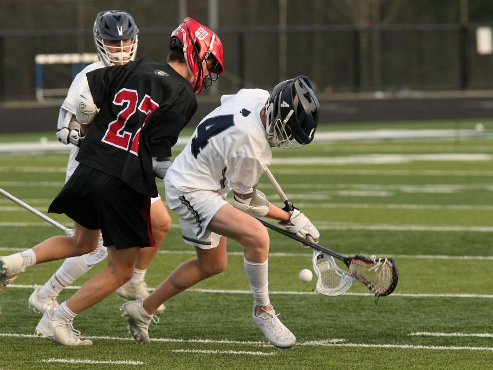 Granville's Hart Miller battles St. Charles' Andrew Ferris for control of the ball Tuesday, March 21, during the Blue Aces' 11-10 loss. 