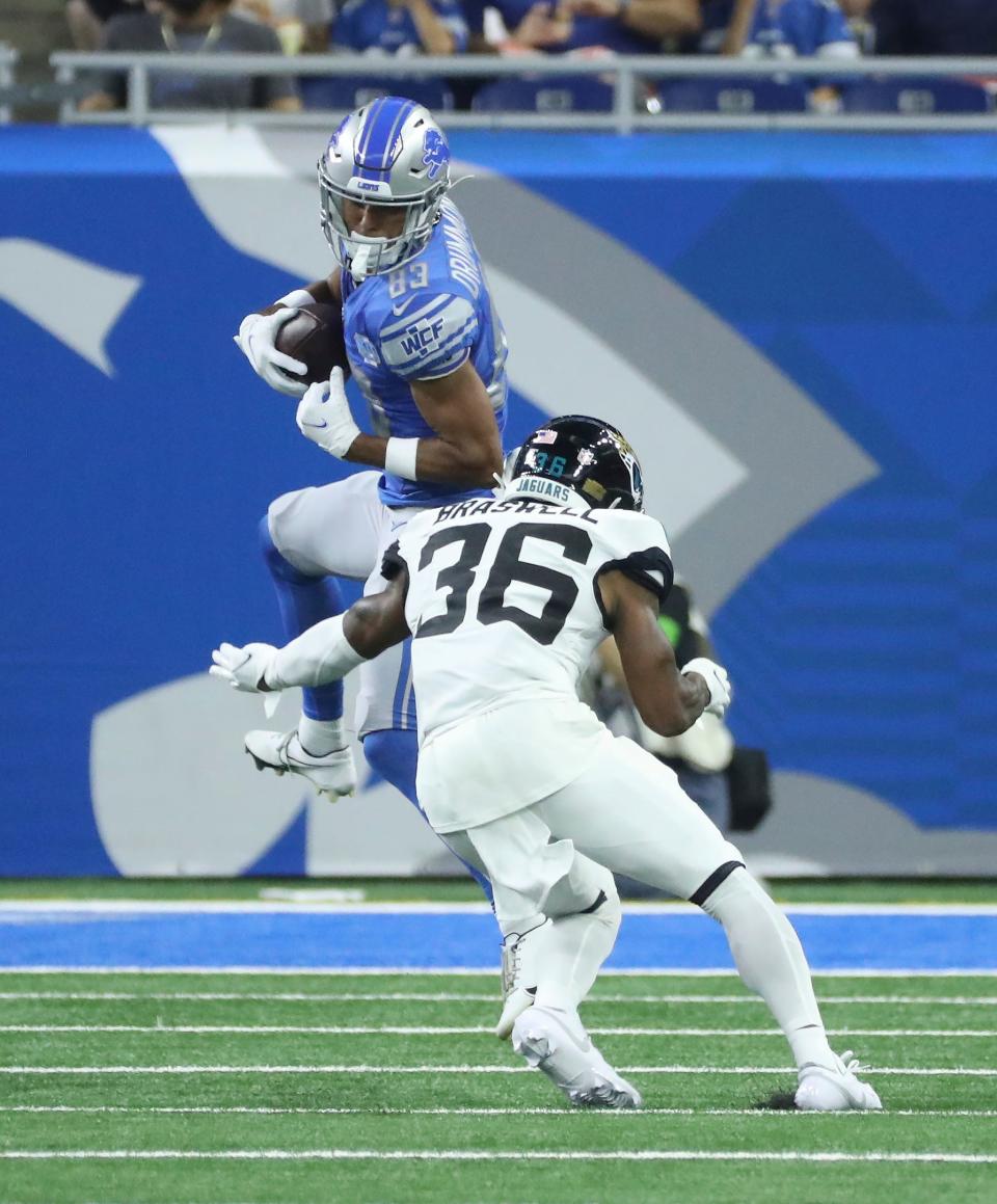 Detroit Lions wide receiver Dylan Drummond (83) makes a catch against Jacksonville Jaguars cornerback Christian Braswell (36) during the first half of a preseason game at Ford Field, Saturday, August 19, 2023.