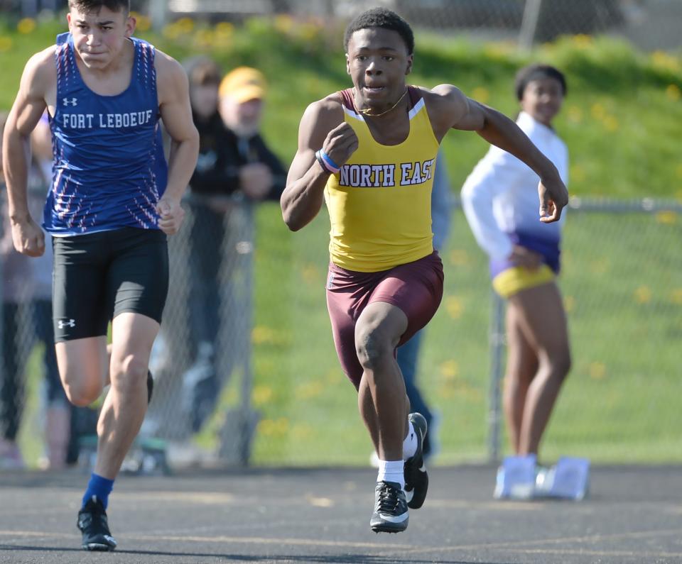 North East junior Jamari Curlett, center, wins a boys 100-meter heat during Saturday's North East Invitational at Ted Miller Stadium.