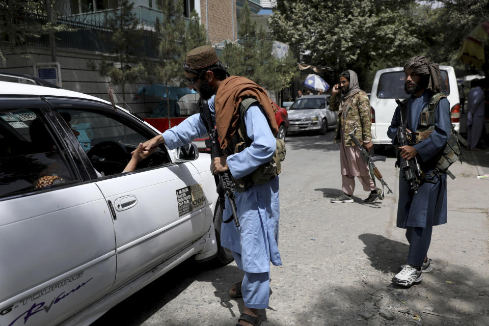 Taliban fighters stand guard at a checkpoint in Wazir Akbar Khan in the city of Kabul, Afghanistan, Wednesday, Aug. 18, 2021. The Taliban declared an "amnesty" across Afghanistan and urged women to join their government Tuesday, seeking to convince a wary population that they have changed a day after deadly chaos gripped the main airport as desperate crowds tried to flee the country. (AP Photo/Rahmat Gul)