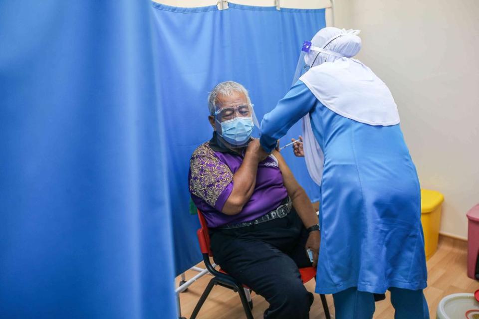 A senior citizen receives a dose of the Sinovac Covid-19 vaccine at the Ar-Ridzuan Medical Centre in Ipoh June 7, 2021. — Picture by Farhan Najib