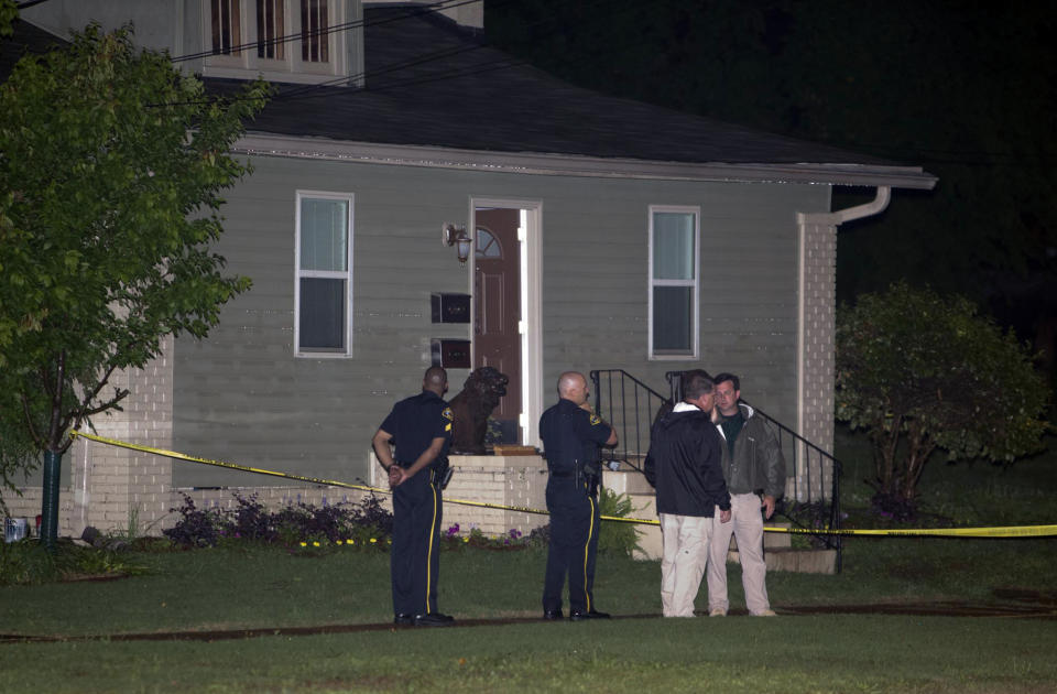 Members of the Tuscaloosa Police Department stand outside of the home where Alabama student John Servati died after taking refuge from a storm on Monday, April 28, 2014. Servati, who was from Tupelo, Miss., was a member of the Alabama swim team. (AP Photo/The Tuscaloosa News, Robert Sutton)