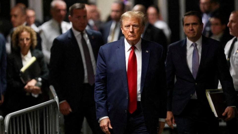 PHOTO: Former President Donald Trump walks outside the courtroom on the day of a court hearing on charges of falsifying business records to cover up a hush money payment to a porn star before the 2016 election, New York City, Feb. 15, 2024.  (Andrew Kelly/Reuters)
