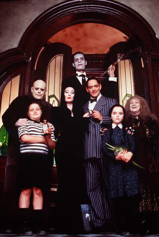 <p>Orion/Paramount/Kobal/Shutterstock</p> Jimmy Workman, Christopher Lloyd, Anjelica Huston, Carel Struycken, Raul Julia, Christina Ricci and Judith Malina in "The Addams Family Values"