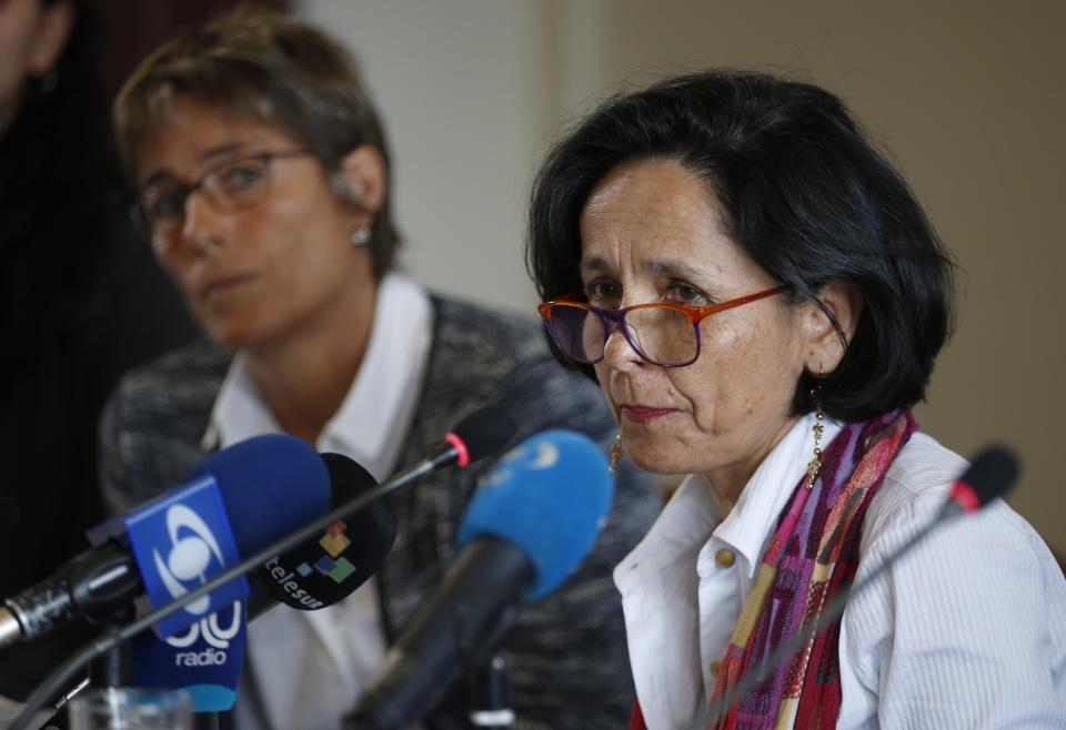 Luz Marina Monzon, left, director of the missing person's unit, speaks during a presentation on information on those disappeared during the nation's civil conflict, in Bogota, Colombia, Tuesday, Aug. 20, 2019. A special unit tasked by Colombia’s peace process to search for the thousands who disappeared over more than five decades of conflict will analyze the information and work with authorities to try and locate remains. (AP Photo/Fernando Vergara)