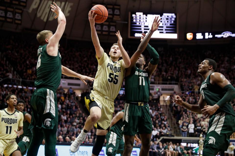 Purdue guard Sasha Stefanovic shoots between Michigan State forward Aaron Henry (11) and forward Thomas Kithier, left, during the second half of MSU's 71-42 loss on Sunday, Jan. 12, 2020, in West Lafayette, Ind.