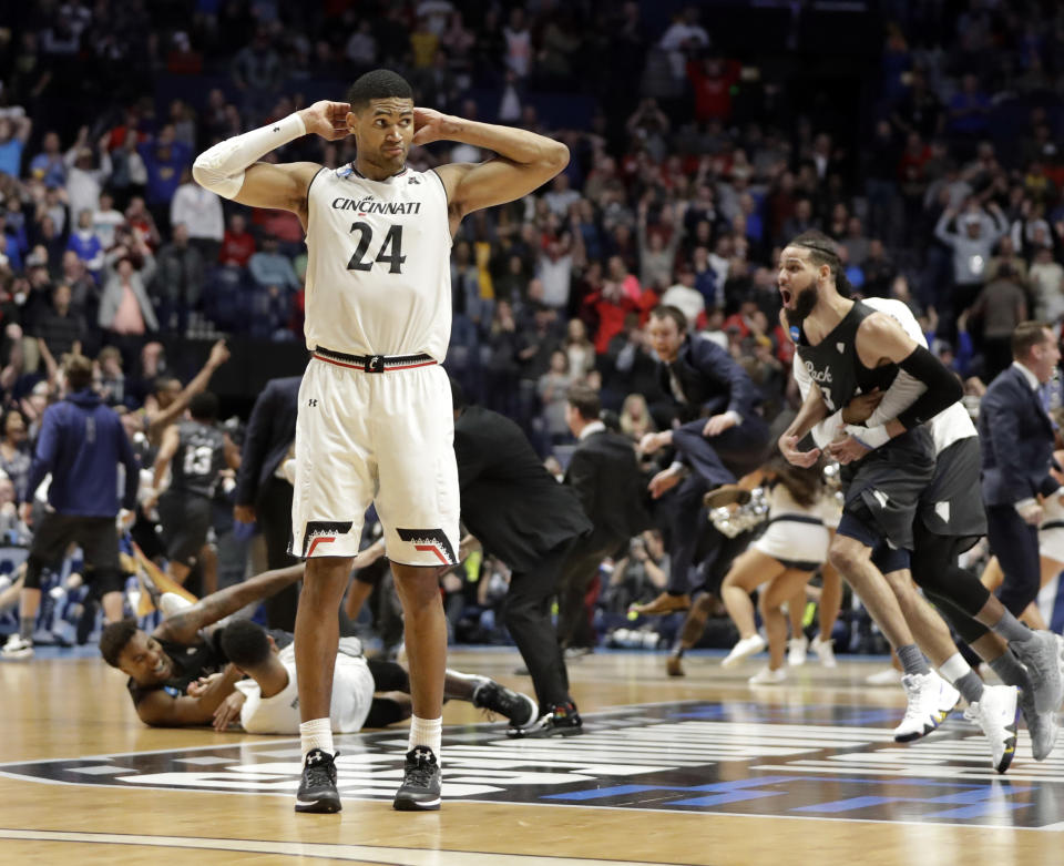 Cincinnati forward Kyle Washington stands on the court as Nevada celebrates its comeback victory in the Round of 32. (AP)