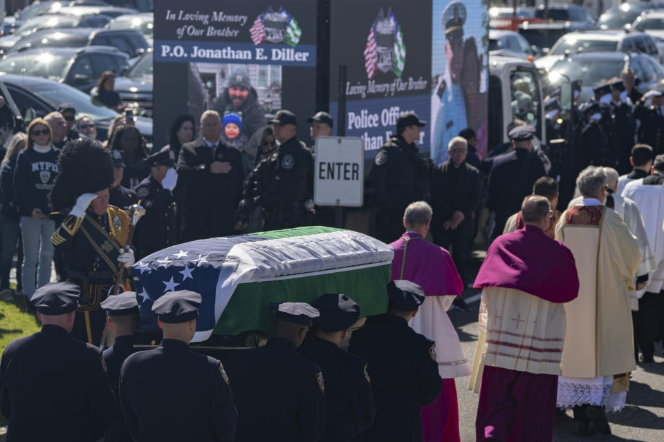 Police officers carry the casket during a funeral service for New York City Police Department officer Jonathan Diller at Saint Rose of Lima R.C Church in Massapequa Park, N.Y., on Saturday, March 30, 2024. Diller was shot dead Monday during a traffic stop. He was the first New York City police officer killed in the line of duty in two years.(AP Photo/Jeenah Moon)