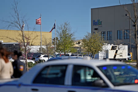 Law enforcement vehicles are seen outside FedEx facility following a blast, in Schertz, Texas, U.S., March 20, 2018. REUTERS/Sergio Flores