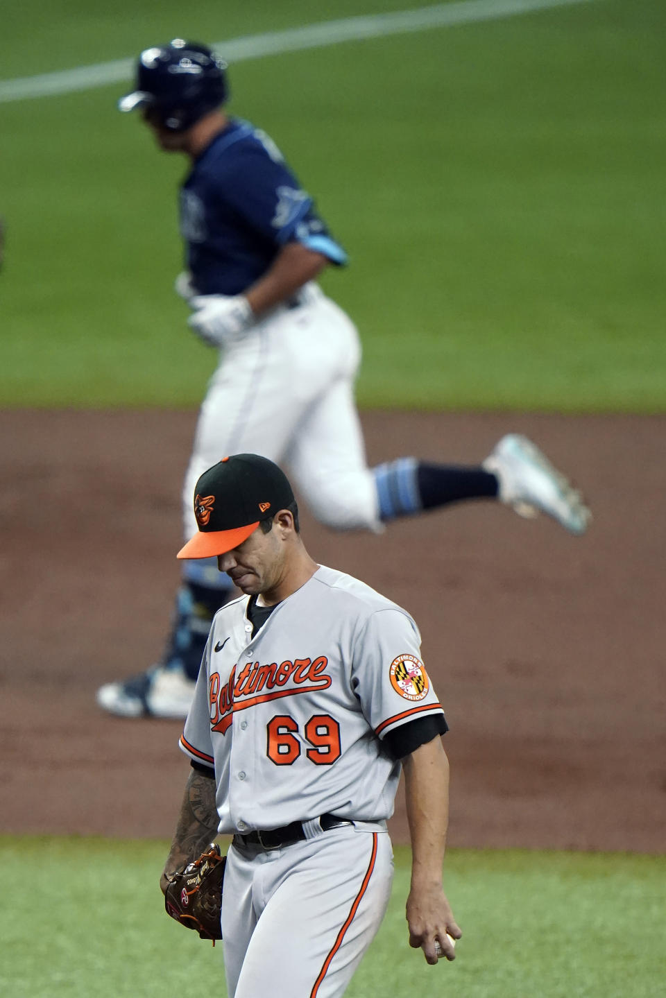 Baltimore Orioles starting pitcher Tommy Milone (69) reacts as Tampa Bay Rays' Hunter Renfroe runs around the bases following his two-run home run during the second inning of a baseball game Tuesday, Aug. 25, 2020, in St. Petersburg, Fla. (AP Photo/Chris O'Meara)